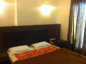 Mathura Hotel Laxmi Bhawan Dharamshala Near Dwarkadhish Temple & Saryu River -Fully Air Conditioning -Free Wi-Fi -Restaurant -Parking -Room Service -Best Hotel In Mathura客房内的一张或多张床位