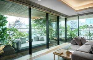 a living room with large glass windows and a couch at ふふ東京銀座 in Tokyo