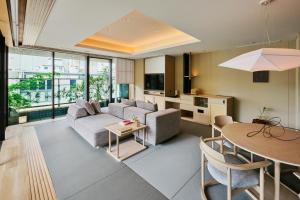 a living room with a couch and a table at ふふ東京銀座 in Tokyo