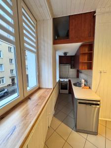 eine Küche mit einer Theke und einem großen Fenster in der Unterkunft Niecała Twelve - Old Town Hideaway in Lublin + 7 Fotos