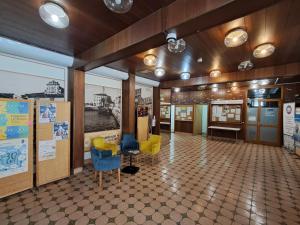 a room with chairs and tables in a building at Mediterranean Rooms Koper in Koper