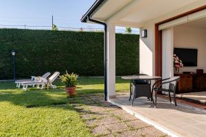 a patio with a table and chairs in a yard at Quinta do Outeirinho - Villa Deluxe in Celorico de Basto