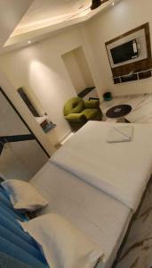 a room with a bed and a table and a chair at Hotel Passion Resort in Kolkata