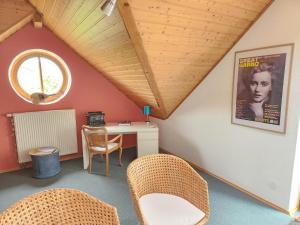 a room with a desk and chairs in a attic at Ferienwohnung in Worms in Worms
