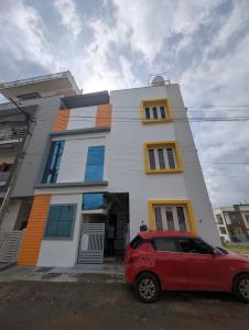 a red car parked in front of a building at Elite Homes in Chikmagalūr +30 photos