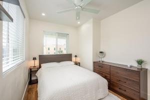 a bedroom with a bed and a ceiling fan at Modern home near Downtown San Diego in San Diego