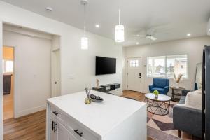 a kitchen and living room with a couch and a tv at Modern home near Downtown San Diego in San Diego
