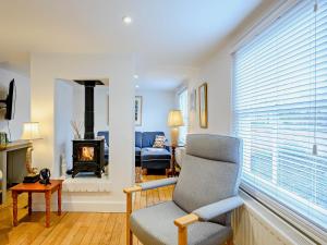 a living room with a chair and a fireplace at 2 Bed in Long Melford 81320 in Long Melford