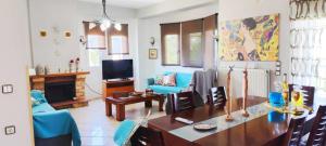 a living room with a table and a blue couch at Maisonette Mangana in Xanthi