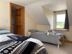 a bedroom with two beds and a window at Bikes Beers Bed and Breakfast in Brosna
