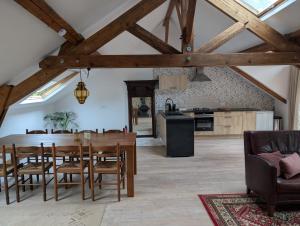 a kitchen and dining room with a wooden table and chairs at Gîte romantique avec charme et confort in Soubrebost +6 photos