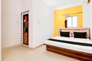 Ένα ή περισσότερα κρεβάτια σε δωμάτιο στο Hotel O Relax INN