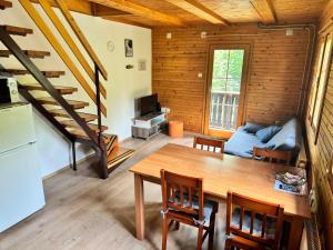 a kitchen and living room with a table and a couch at Hiša Jelka in Kranjska Gora