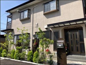 a house with a sign in front of it at 茶々ハウス in Fujiyoshida