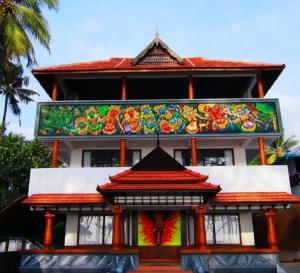 a building with a painting on the side of it at Relax inn cherai beach in Cochin