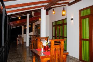 a dining room with a table and some chairs at Jasmine Villa in Bentota