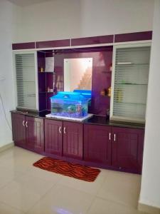 a large aquarium with a blue tank in a room at Farah Homestay in Varkala