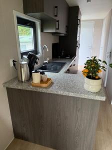a kitchen with a counter top with a sink and a counter top at Nieuw in 2025! Modern vakantiehuis aan de Waddenzee in Westerland