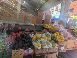 a market with lots of fruits and vegetables in boxes at Sakura Fan 2F in Tokyo