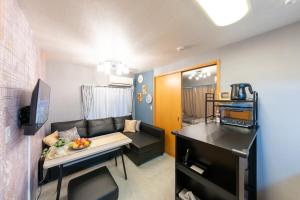 a small living room with a couch and a table at Sakura Fan 2F in Tokyo