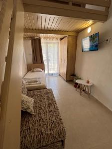 a room with two beds and a table in it at Villa Mia apartments in Sutomore