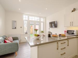 a kitchen with a counter top and a living room at 1 Bed in Old Colwyn 78154 in Old Colwyn +12 photos