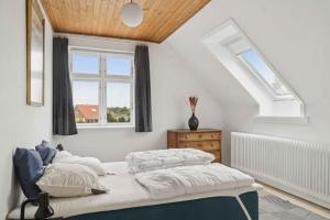 a bedroom with two beds and a window at Holiday Home With Billiards, Garden, Great Spot in Grenå