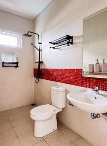 a bathroom with a toilet and a sink at Villa Loft Paradise in Nusa Dua