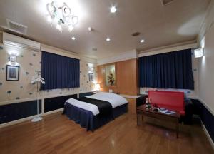 a hotel room with a bed and a table at Hotel Mio Resort ( Adult Only) in Yokkaichi +9 photos