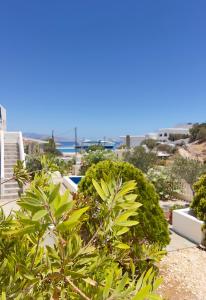 a view from the balcony of a house with plants at Aegean Star Hotel in Karavostasi