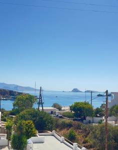 a view of the ocean from a house at Aegean Star Hotel in Karavostasi