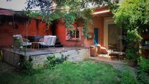 a patio with a table and chairs in a backyard at chambre condamine spa in Millau