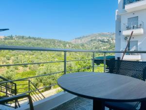 a table on the balcony of a building at Petros rooms in Himare