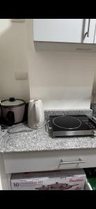 a kitchen counter with a stove and a pan on it at Davao Condo Near Airport & Malls in Davao City