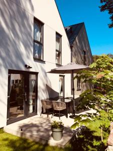 a patio with a table and an umbrella at Playa Pobierowo in Pobierowo