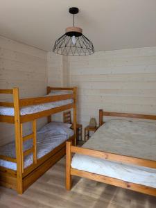 a room with two bunk beds and a light at Appartement du Planet in Saint-François-Longchamp