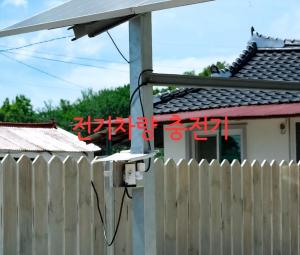 a house with a fence and a pole with a building at Buan Hwayangyeonhwa Pension in Buan +21 photos