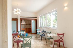 a dining room with tables and chairs and a window at Castellinaria Holiday in Castellana Grotte