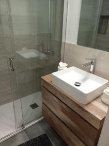 a bathroom with a white sink and a shower at KaSsAnDrA HoUsE in Barcelona +20 photos