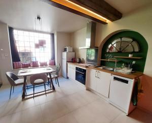 a kitchen with a table and chairs in a room at Les gîtes de Wissembourg - La Tannerie in Wissembourg