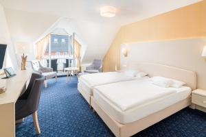 Postel nebo postele na pokoji v ubytování Hotel Inselfriede