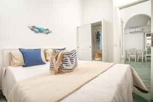 a bedroom with a large bed with pillows on it at BILANCIA VI 30' Porto Cervo & PRIVATE TERRACE with Sea View in Santa Teresa Gallura