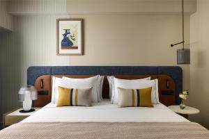 a bedroom with a large bed with a blue headboard at Tivoli Oriente Lisboa Hotel in Lisbon