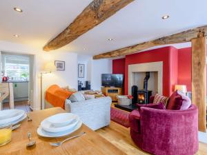 a living room with a table and a fireplace at 2 Bed in Tideswell 81534 in Tideswell