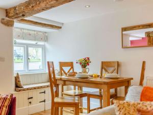 a dining room with a wooden table and chairs at 2 Bed in Tideswell 81534 in Tideswell