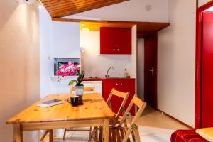 a kitchen and dining room with a wooden table and chairs at LE HAMEAU DES ETOILES in Fleurance
