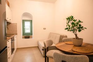 a kitchen and living room with a table and a couch at Rosette Apartments in Pyrgi +14 photos