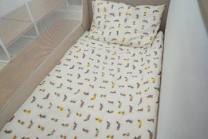 a bed with a comforter with horses on it at 7Seas City-Apartment Kaiserslautern - Balkon l NETFLIX l 24h Self Check-in in Kaiserslautern