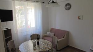 a small living room with a table and a chair at Apartments Furlan in Portorož
