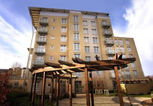 a tall building with a structure in front of it at Reading Modern Two Bedroom Apartment in Reading